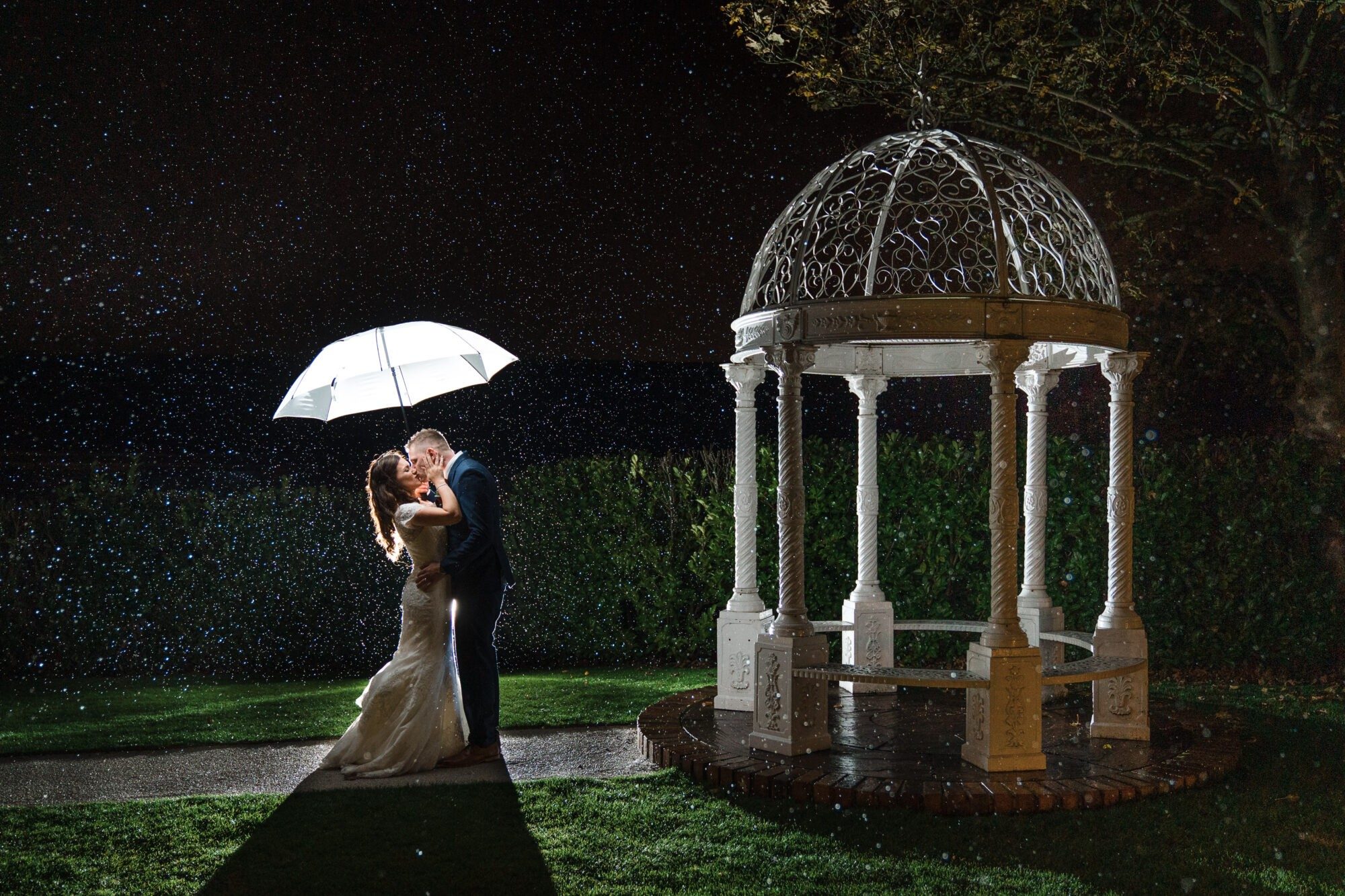 Dramatic photograph of couple in the evening on their wedding day in Nottingham next to the gazebo