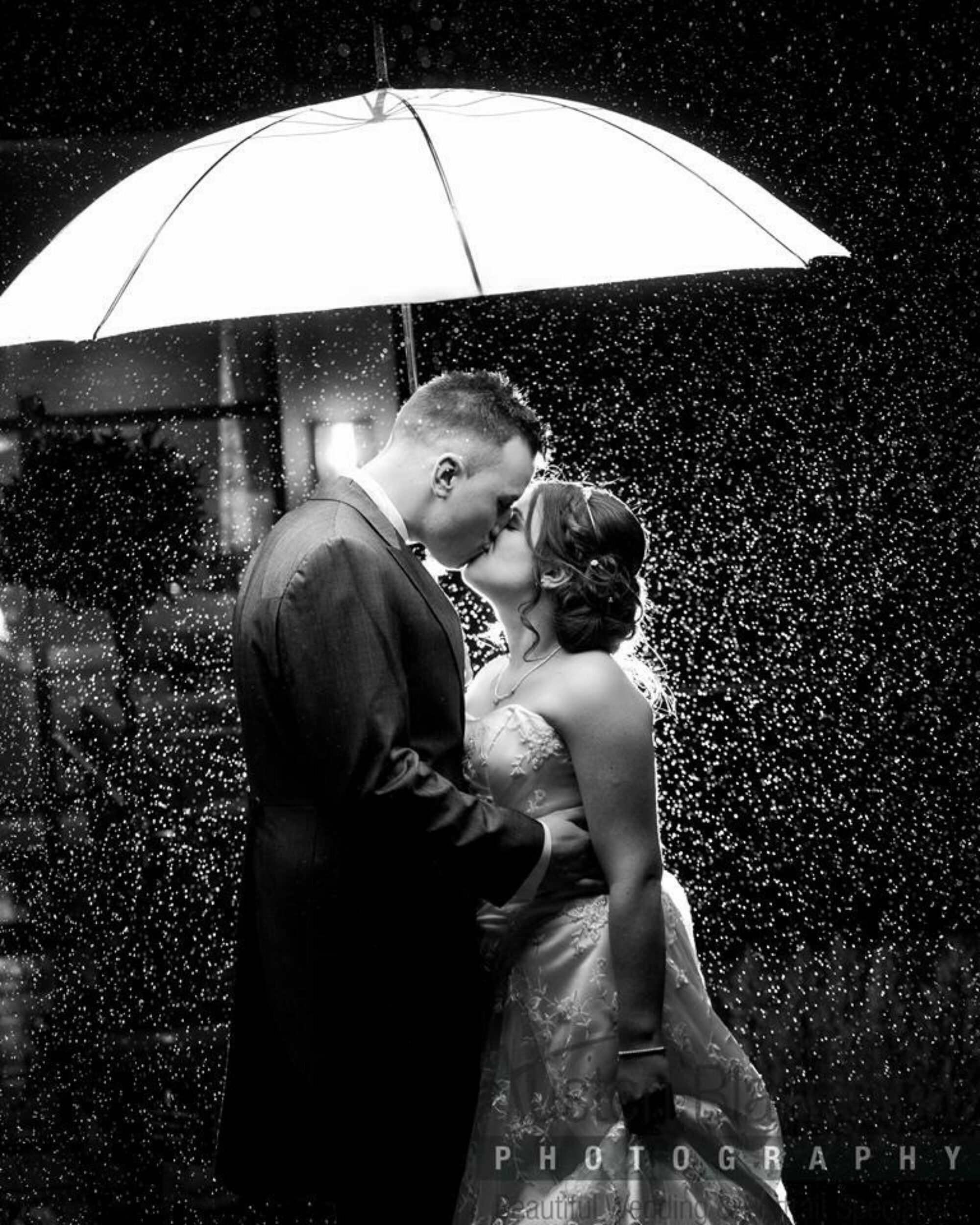 Black and white photo of a couple at their wedding in Nottingham kissing