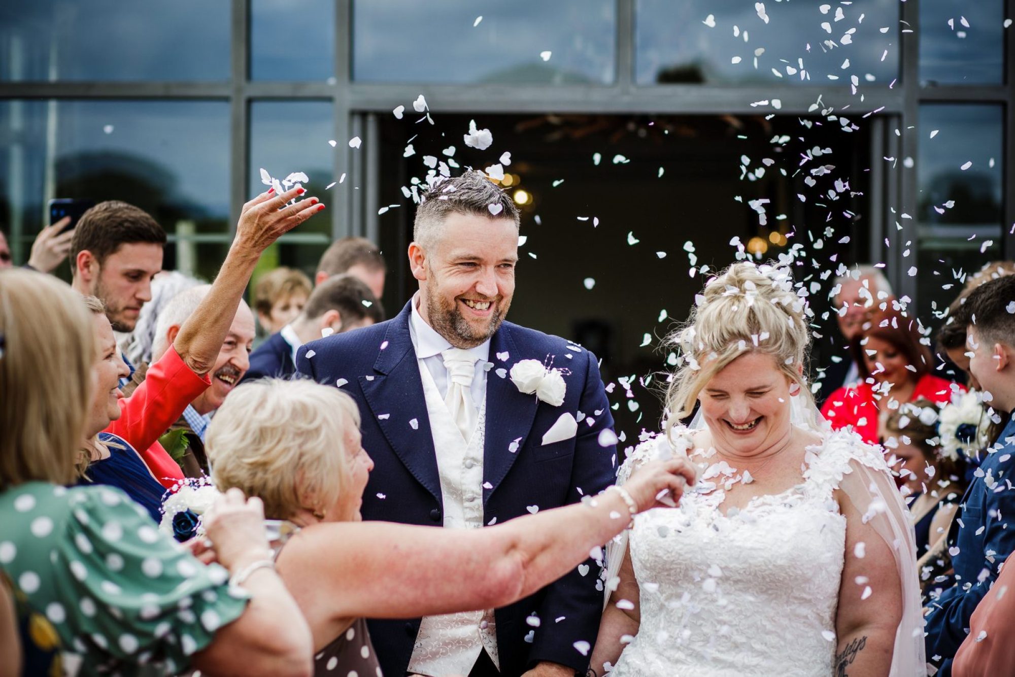 Wedding guests throwing confetti on happy couple on their wedding day in Nottingham